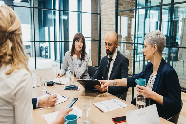 Professional team in a modern office discussing managed IT solutions and digital tools for accounting firm operations and efficiency