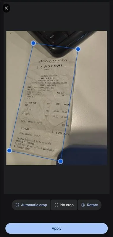 Mobile receipt scanning interface showing manual crop adjustment with corner handles before OCR processing, including crop, rotate, and apply options.
