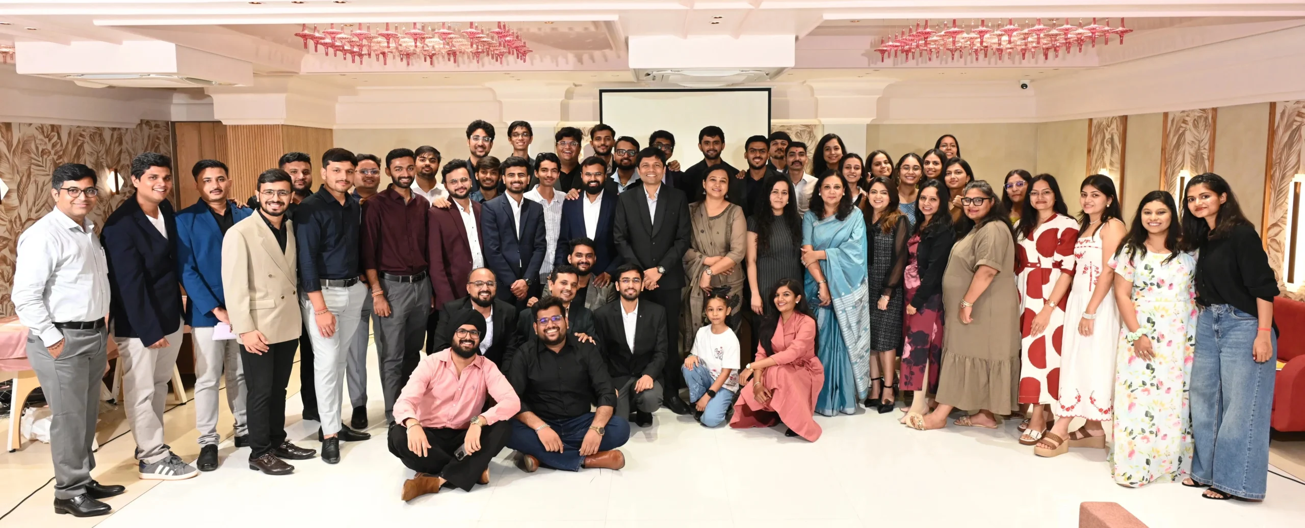 Company team group photo at a corporate event with employees gathered together for a team celebration.